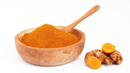 Turmeric powder or Kunyit bubuk, served in wooden bowl, copy space.
