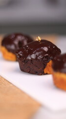 three cakes with frosted and gold chocolate topping and crunchy chocolate filling