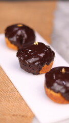 three cakes with frosted and gold chocolate topping and crunchy chocolate filling