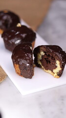 three cakes with frosted and gold chocolate topping and crunchy chocolate filling