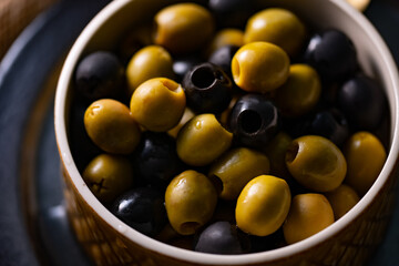 Green and Black Olives.This close-up features vibrant green and rich black olives, perfect for...