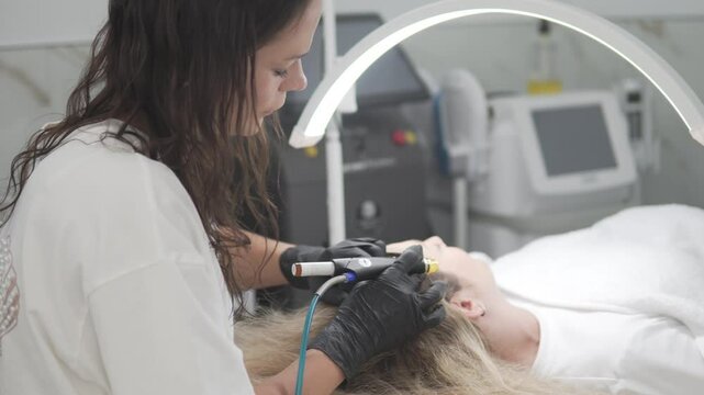 Professional HydraFacial Keravive scalp treatment in a modern aesthetic clinic