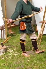 Medieval Archer Crafting a Wooden Bow. Handmade Archery Bow at Medieval Festival. Historical...