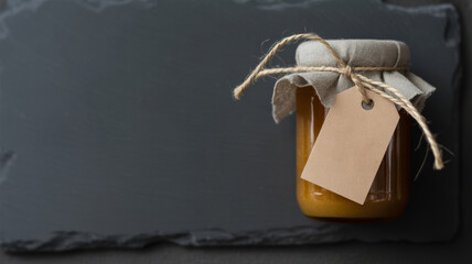 Homemade Preserves in Glass Jar with Blank Label on Slate Background Still Life