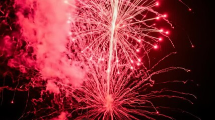 Exploding red firework with smoke and sparks on black background, celebration. - Powered by Adobe