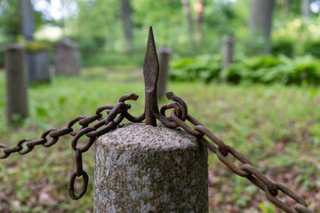 Old Iron Chain and Spear Point on Graveyard Pillar – Guarding Memory and Peace in Nature