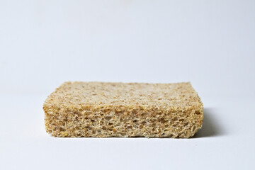 Side view of one whole wheat sliced bread with abstract product background. Isolated on white. Clipping path. Close up.