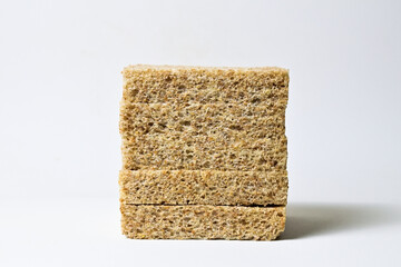 Side view of whole wheat sliced bread with abstract product background. Isolated on white. Clipping path. pile, stack. close up.