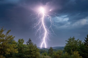 A vibrant lightning bolt dominates the sky above a forested landscape illuminating the stormy atmosphere
