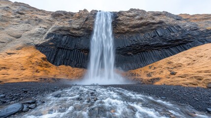 Obraz premium Iceland Waterfall Cascading Over Colorful Cliffs