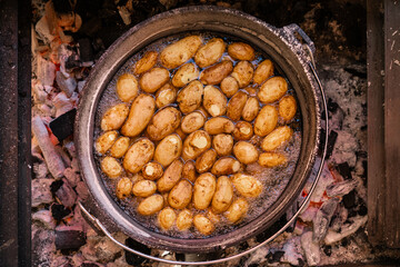 Potatoes Cooking in a Dutch Oven over Open Flame – Rustic Outdoor Meal