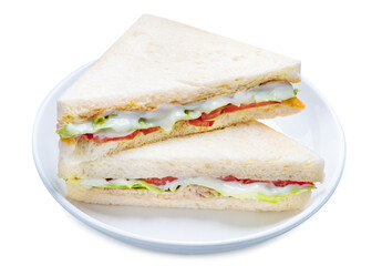 Sandwich with fresh vegetables and creamy salad dressing on a white plate isolete on white background with clipping path .