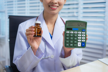A confident Asian female veterinarian sits at her desk, calculating pet care costs using a...