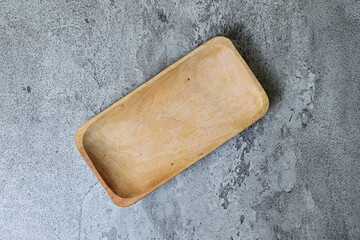 Top view of empty rectangular wooden plate. grey or gray cement as background. Copy space, empty...