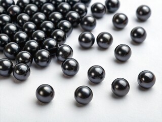 Scattered black pearls on white background