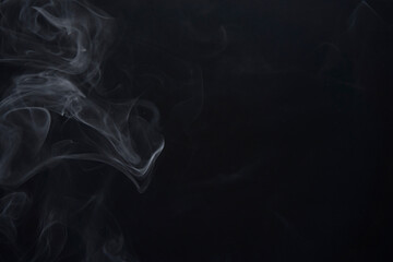 White Smoke Swirls on Black Background for Composite Use

