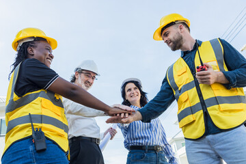 Diverse Construction engineer profession workers people join hands, Group of multiethnic company.