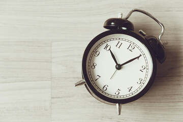 Bell clock old retro style at wooden background with copy space for text, history memory time