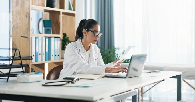 Doctor, laptop and woman with paperwork in office for clinic admin, diagnostic info or medical report. Healthcare, expert and reading health website for treatment plan, results comparison or research