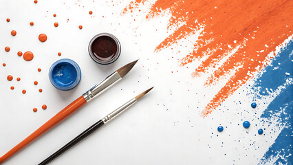 Two paint brushes and paint pots with orange and blue paint splatters on a white background