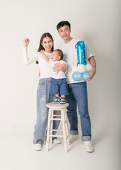 Family Poses Together in a Studio Portrait With Joyful Smiles and Playful Atmosphere