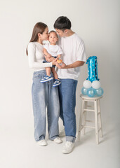 Family Poses Together in a Studio Portrait With Joyful Smiles and Playful Atmosphere