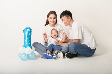 Family Poses Together in a Studio Portrait With Joyful Smiles and Playful Atmosphere