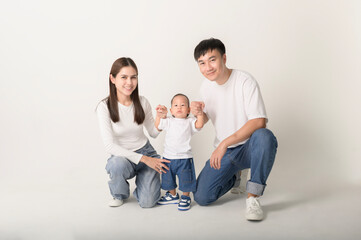 Family Poses Together in a Studio Portrait With Joyful Smiles and Playful Atmosphere