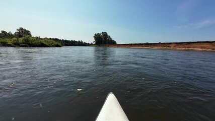 Enjoy a peaceful kayaking trip on a serene river, surrounded by lush greenery and blue skiesideal for nature lovers and outdoor enthusiasts seeking relaxation and fun in natures beauty