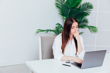 Business woman working on laptop at office desk online