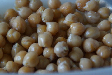 A close-up of golden-hued dried chickpeas, artfully arranged to highlight their rustic texture and natural warmth. A quiet tribute to this humble ingredient, a staple across many world cuisines.