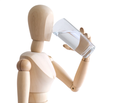 Wooden mannequin drinking water from a clear glass on a white background.