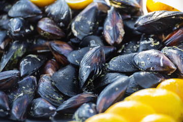 Fresh Turkish street food with black mussels and lemon, close-up shot