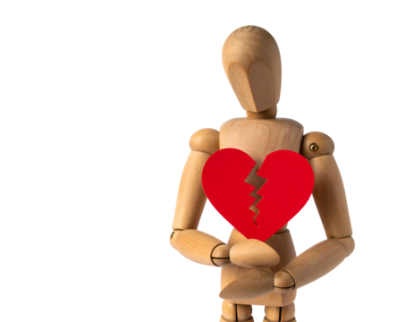 Wooden mannequin holds a broken red heart, symbolizing heartbreak and emotional pain. - Powered by Adobe