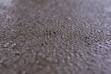 raindrops on pavement, Rain drops on asphalt or tarmac road creating ripples, The floor is covered with moss from rain