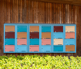 Colorful Mailboxes on Wooden Wall