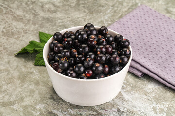 Ripe black currant in the bowl