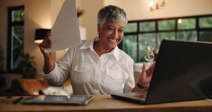 Senior woman, laptop and celebration with paperwork in home for good news, debt free and savings. Retirement, old person and dancing with documents for investment growth, financial success or excited
