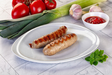 Grilled pork sausages served tomato sauce