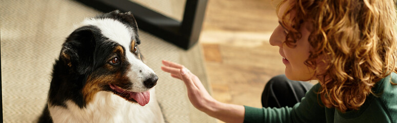 Young man enjoying a cozy moment with his dog at home during a peaceful afternoon