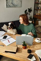 Cozy moments at home with a young man and his friendly dog during a productive afternoon