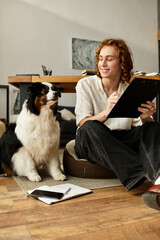 Cozy afternoon spent at home with a young man and his dog engaged in creativity and relaxation