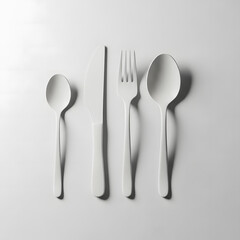 White cutlery set, minimalist design,  on a plain background.