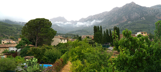 View of Soller Mallorca with low cloud in front of Tramuntana mountains 