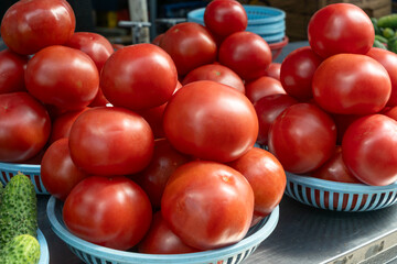 Vibrant red tomatoes symbolizing the essence of life and growth. Fresh tomatoes on display at a bustling market, inviting a taste of summer.