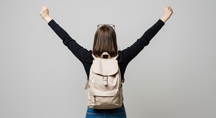 Young woman with hands raised, expressing joy and success
