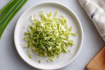 Finely chopped lemongrass on clean white plate, perfect for culinary use