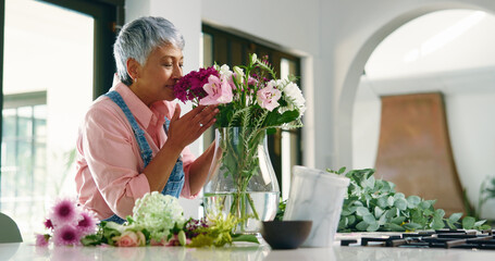 Old woman, smell and flowers aroma at house for special occasion, aesthetic and bloom scent. Senior person, arrangement and plant fragrance for floral bouquet, hospitality decoration and resort setup