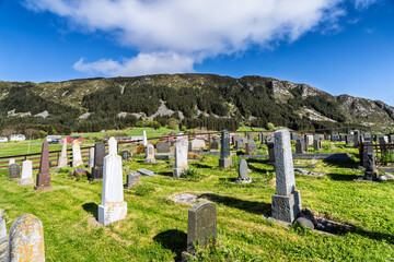 Peaceful Cemetery Overlooking Scenic Landscape Under Bright Blue Sky, Runde, Norway