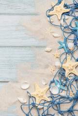 Fishing net, seashells and starfishes creating summer holiday border on wooden planks
